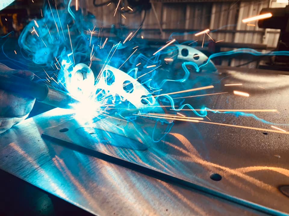 Custom Hinges Being Welded Onto A Fire Box Door 